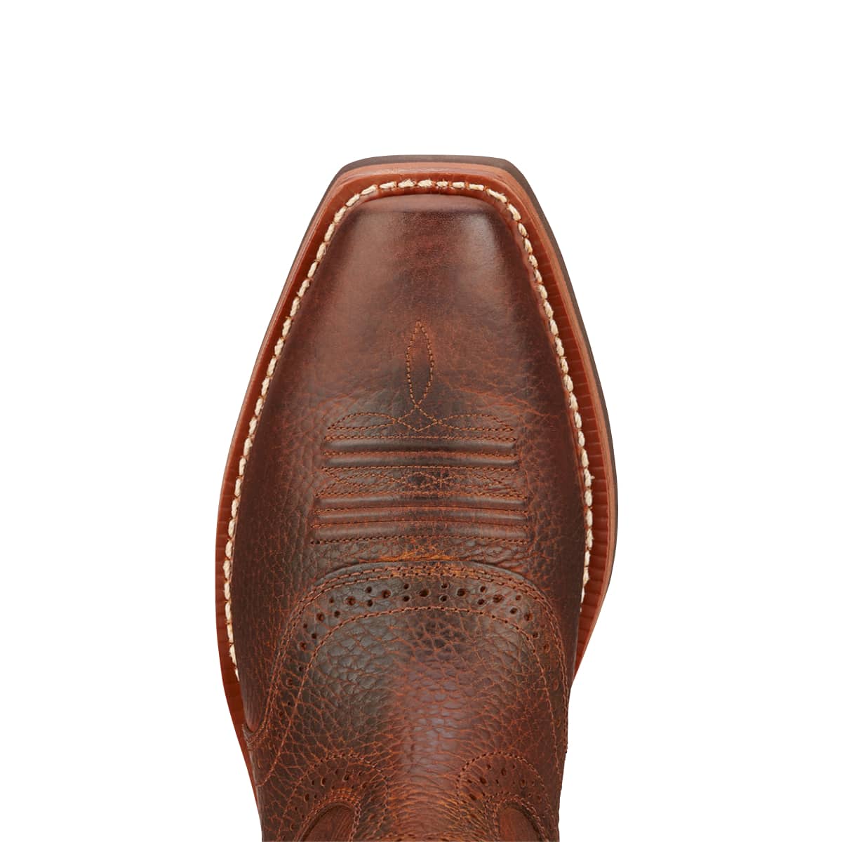 Top-down close-up of a brown leather Ariat cowboy boot toe showing the textured leather, decorative stitching, and contrast welt stitching on a white background.