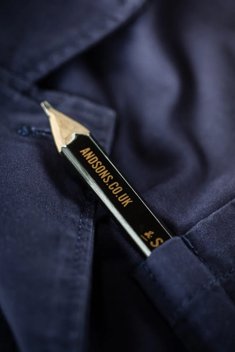 Pencil with 'AND SONS CO. UK' branding sticking out of a blue fabric pocket.