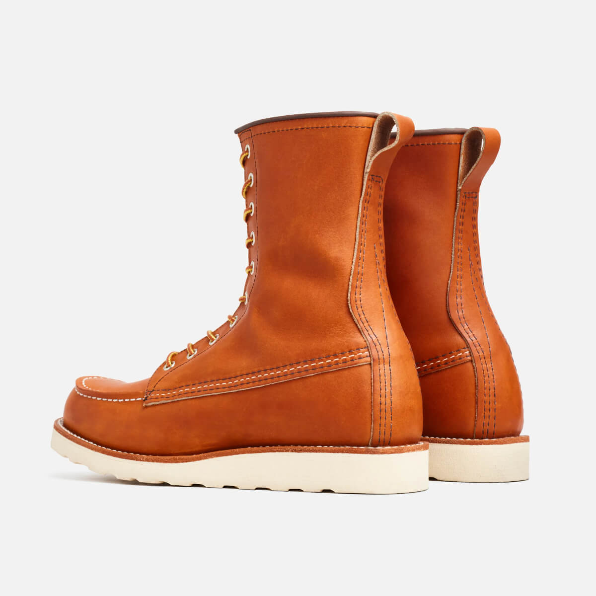 Pair of brown leather boots on a light gray background
