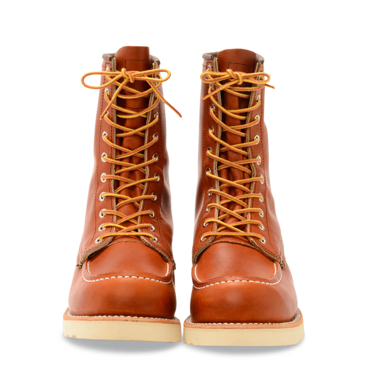 Pair of brown leather boots with orange laces on a white background