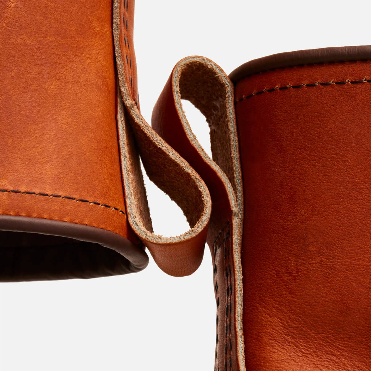 Close-up of brown leather boot with a white background