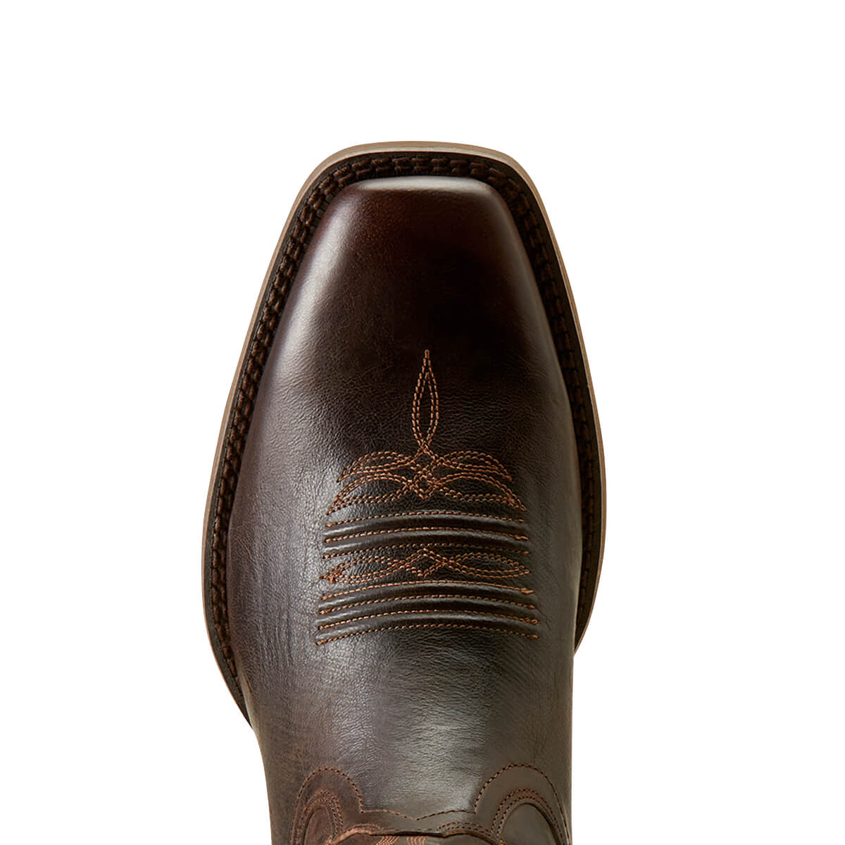 Close-up of a brown leather boot with intricate stitching on a white background