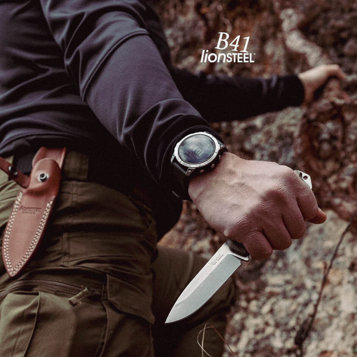 Person holding a knife with a watch and leather sheath in a natural setting, featuring Lionsteel branding.