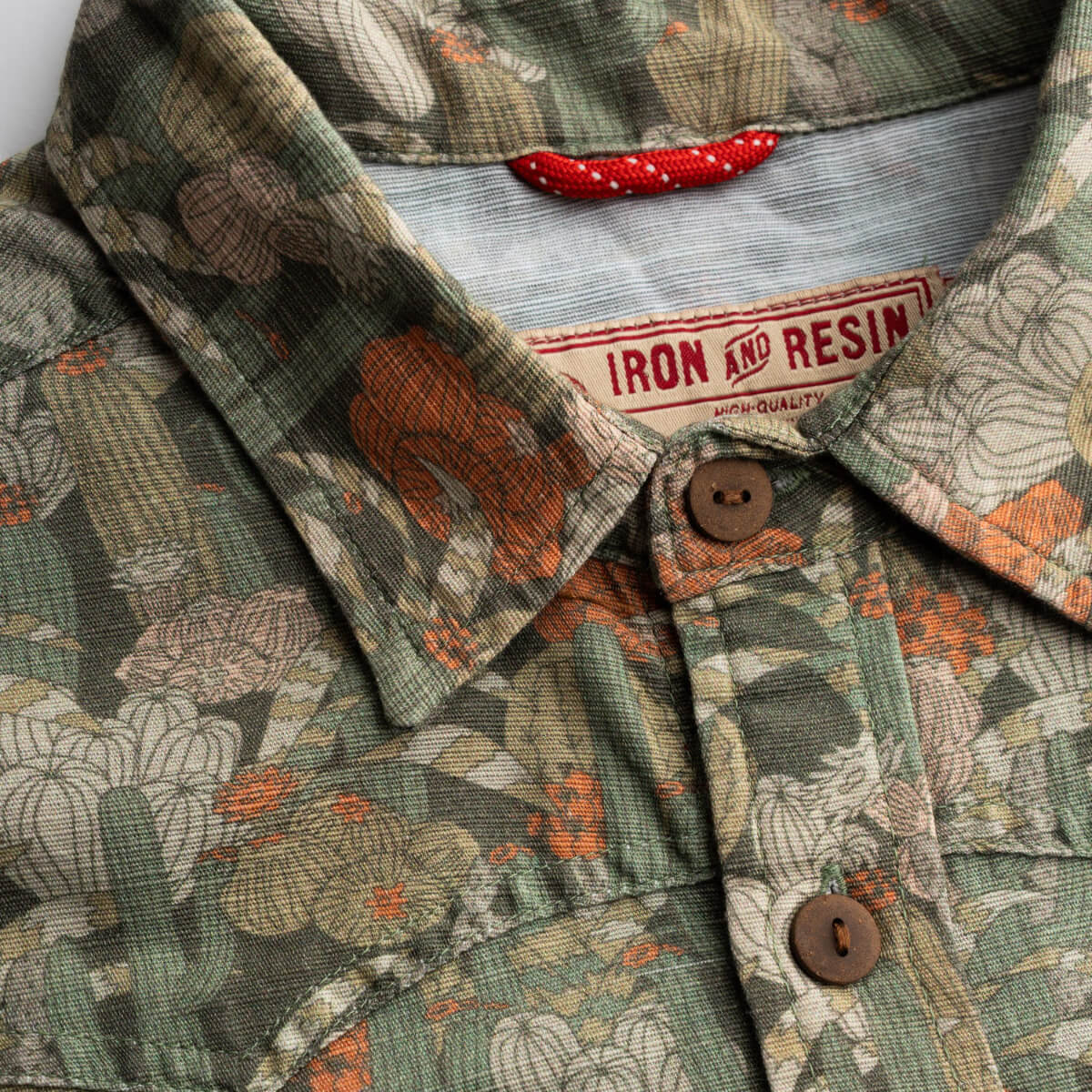 Floral patterned shirt with a brand label on a white background