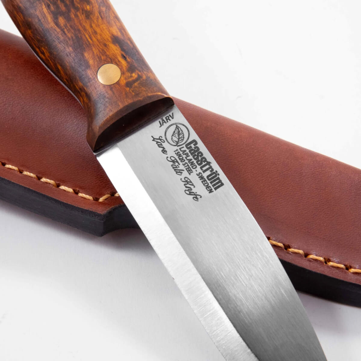 Knife with wooden handle and leather sheath on a white background