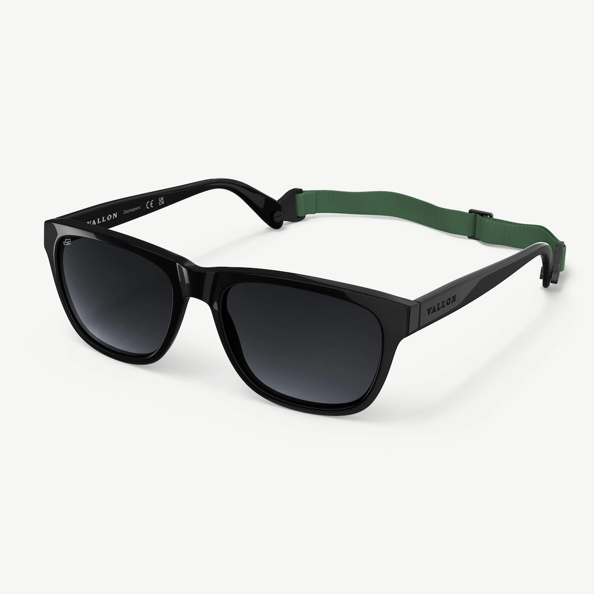 Black Vallon sunglasses with a green strap on a white background