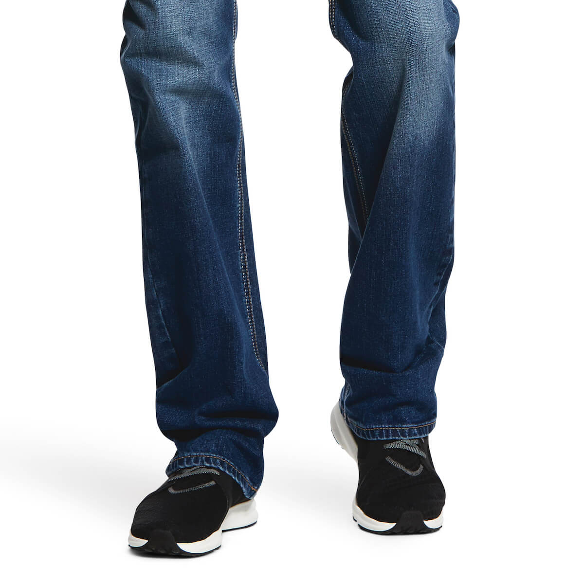 Blue jeans worn by a person on a white background