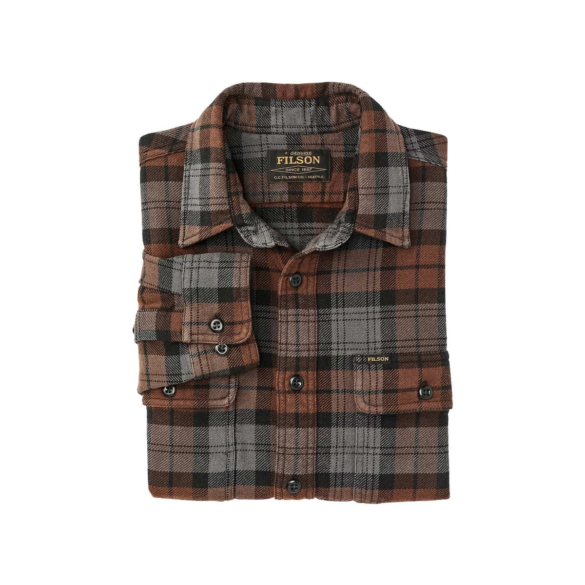 A folded Filson plaid flannel shirt in brown, black, and gray, displayed flat against a light beige background.