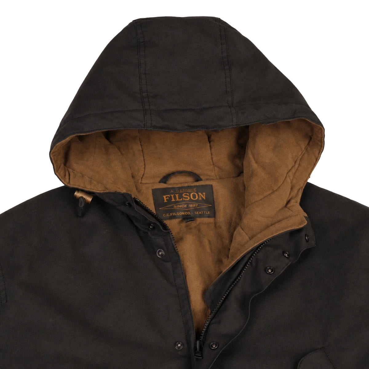 Close-up of a Filson hooded jacket showing a black waxed cotton exterior and a warm brown fleece interior lining, with the Filson brand label visible at the collar.