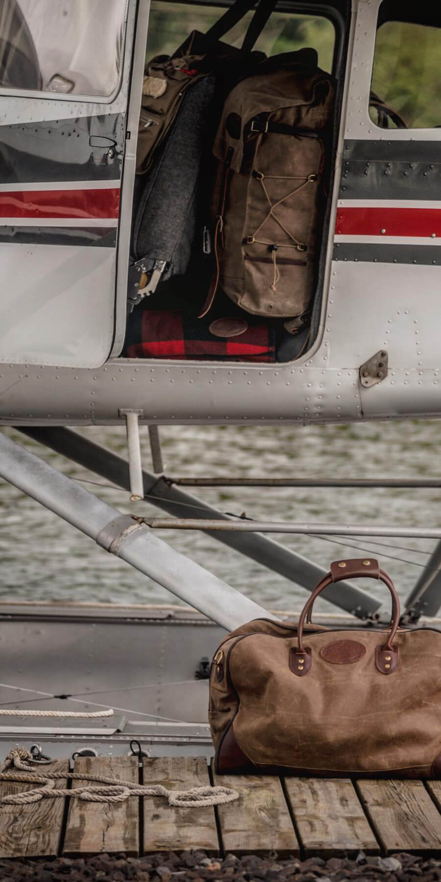Brown leather bag on a wooden platform with a helicopter in the background