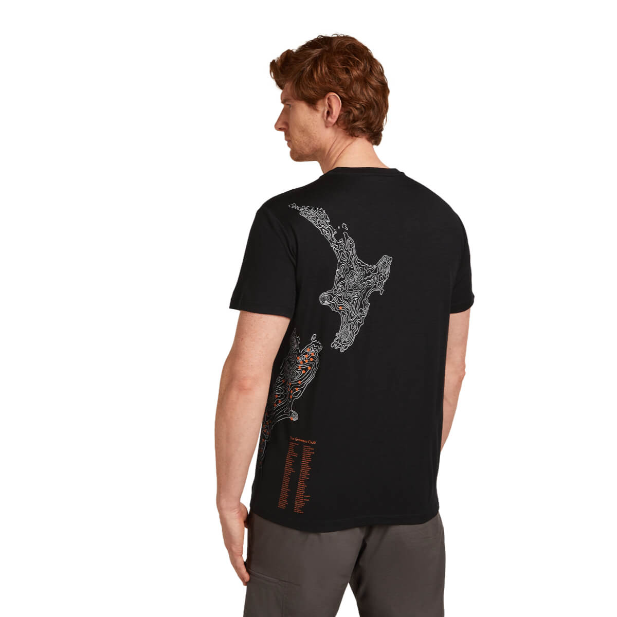 Man wearing a black t-shirt with a graphic design on the back, standing against a white background