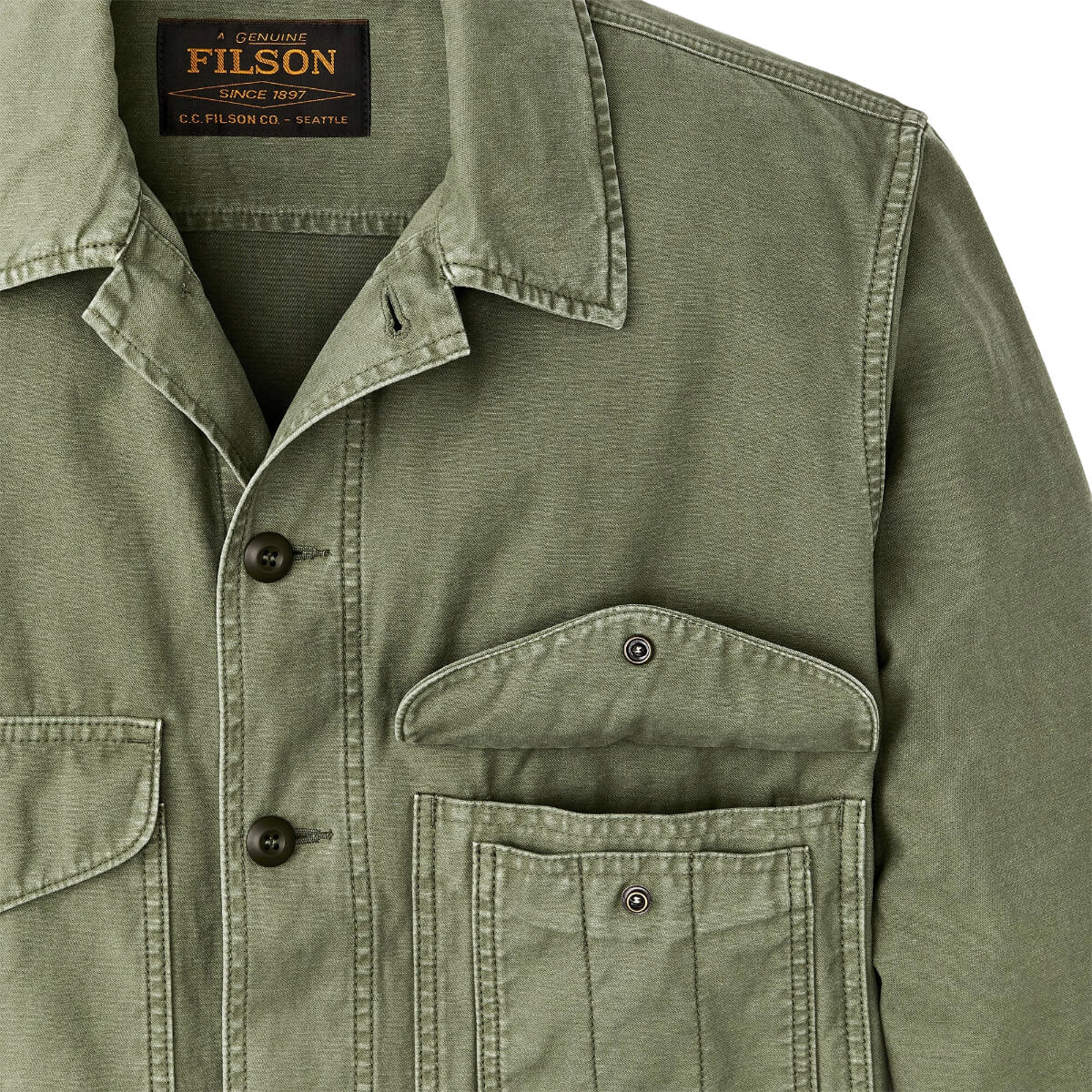 Green jacket with visible Filson branding on a white background