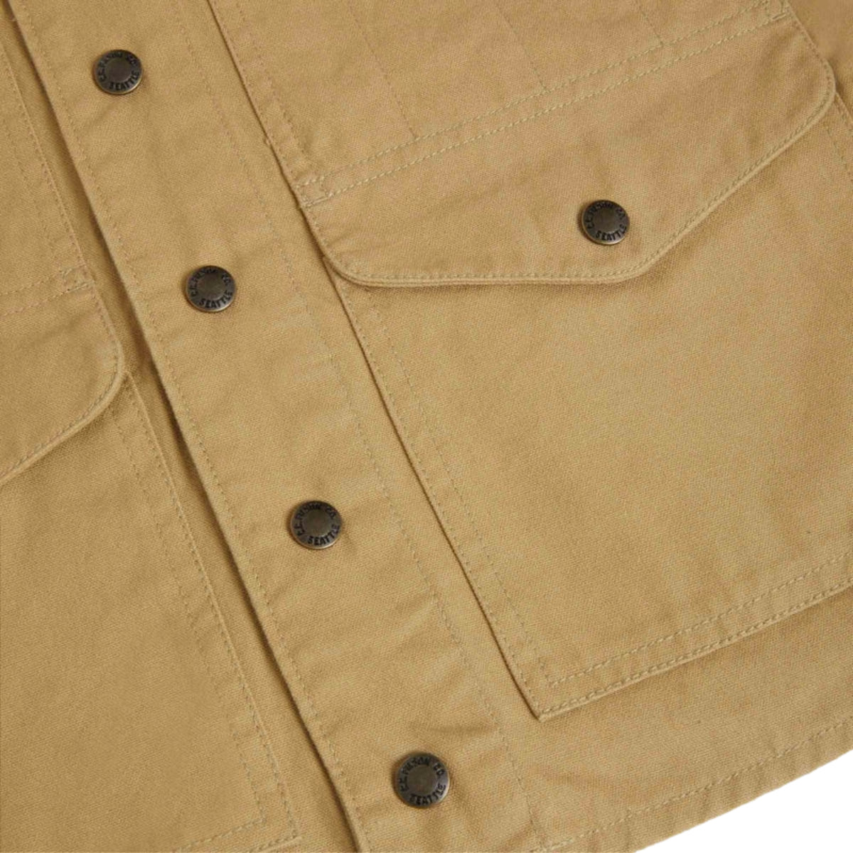 Close-up of a beige jacket with button details on a white background