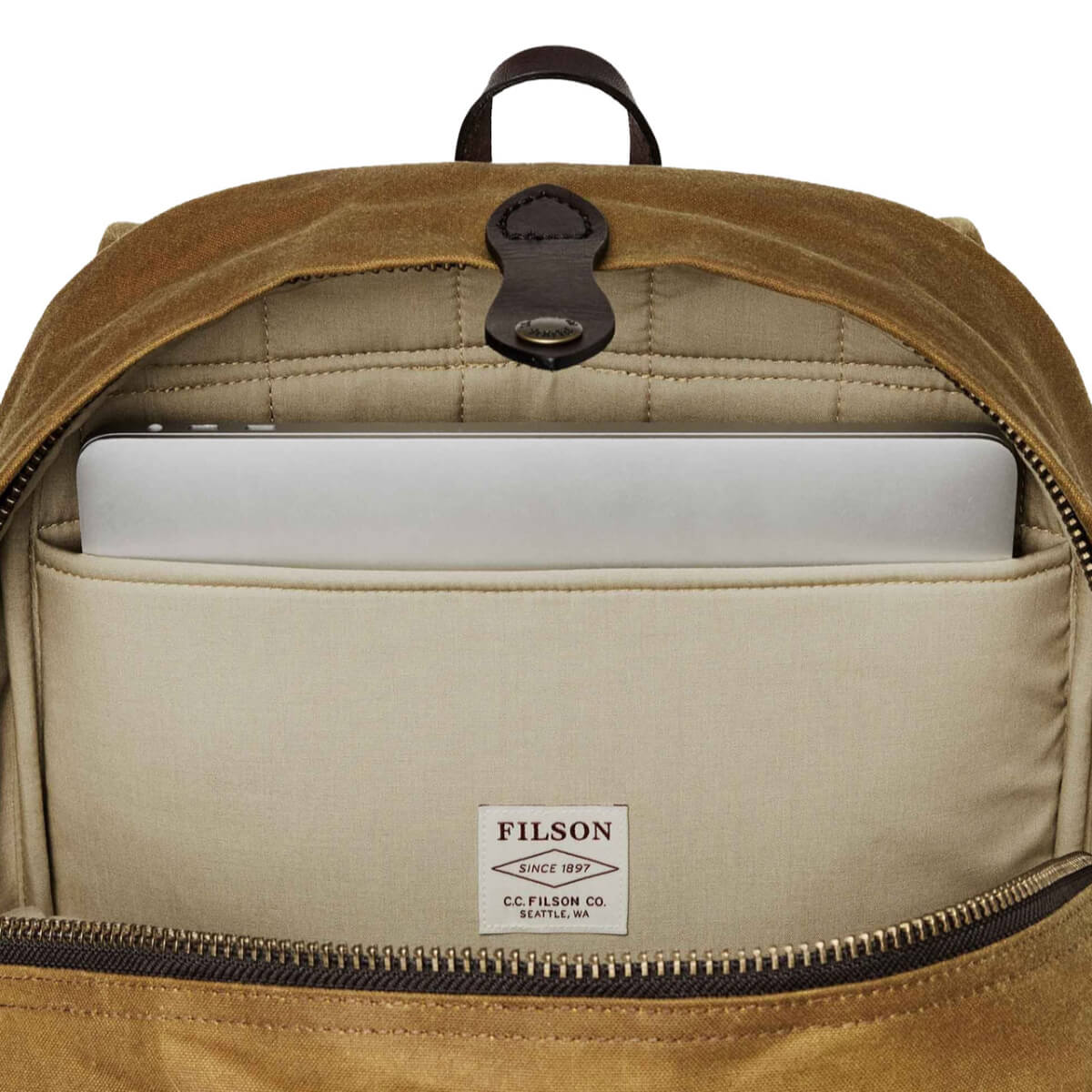 Beige backpack with a laptop compartment and Filson logo.