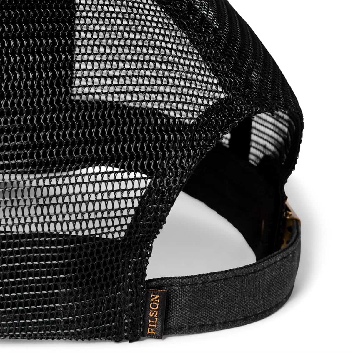 Close-up of the back of a black Filson mesh trucker hat showing the adjustable strap and a small FILSON brand tag on a white background.