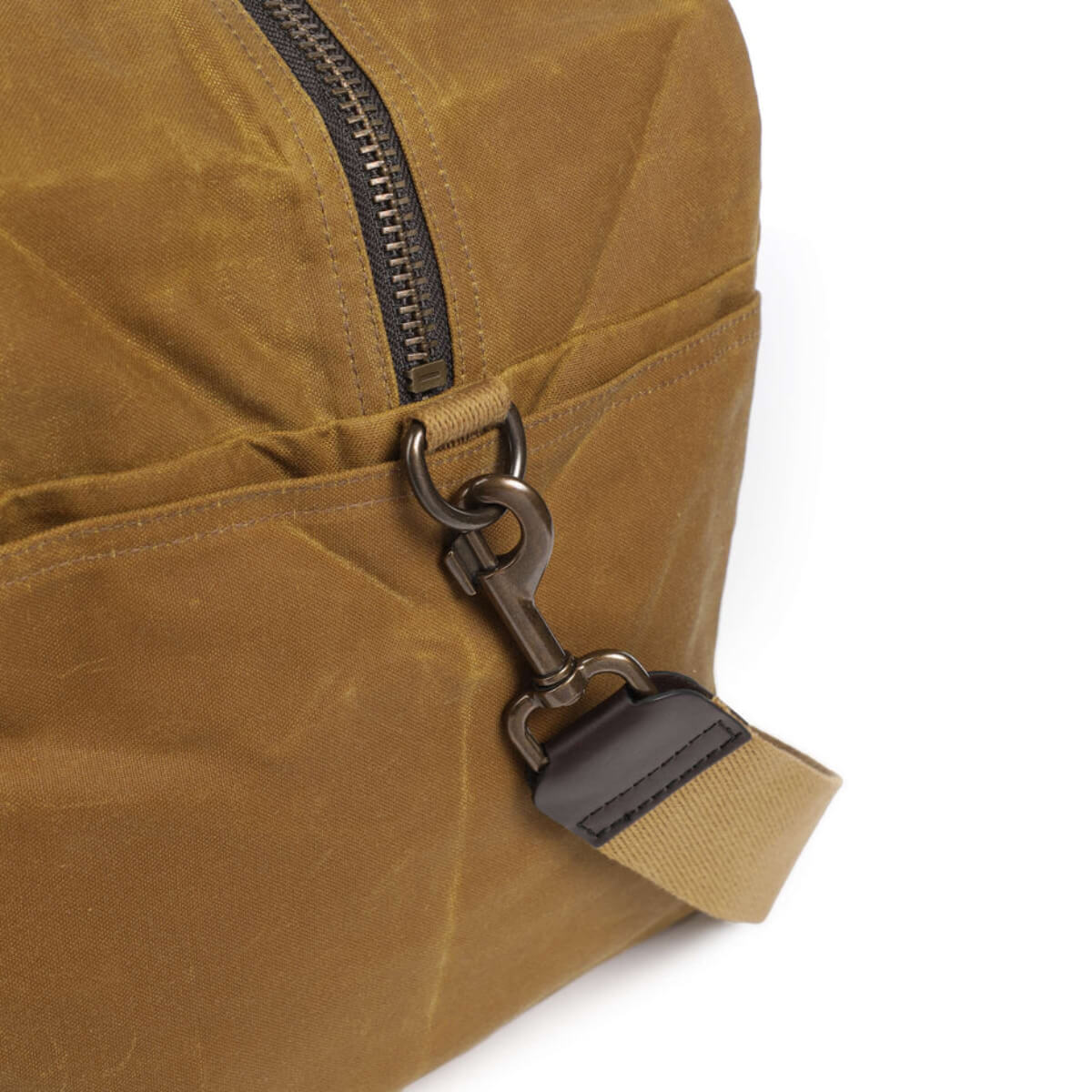 Close-up of a brown backpack with a metal clasp on a white background