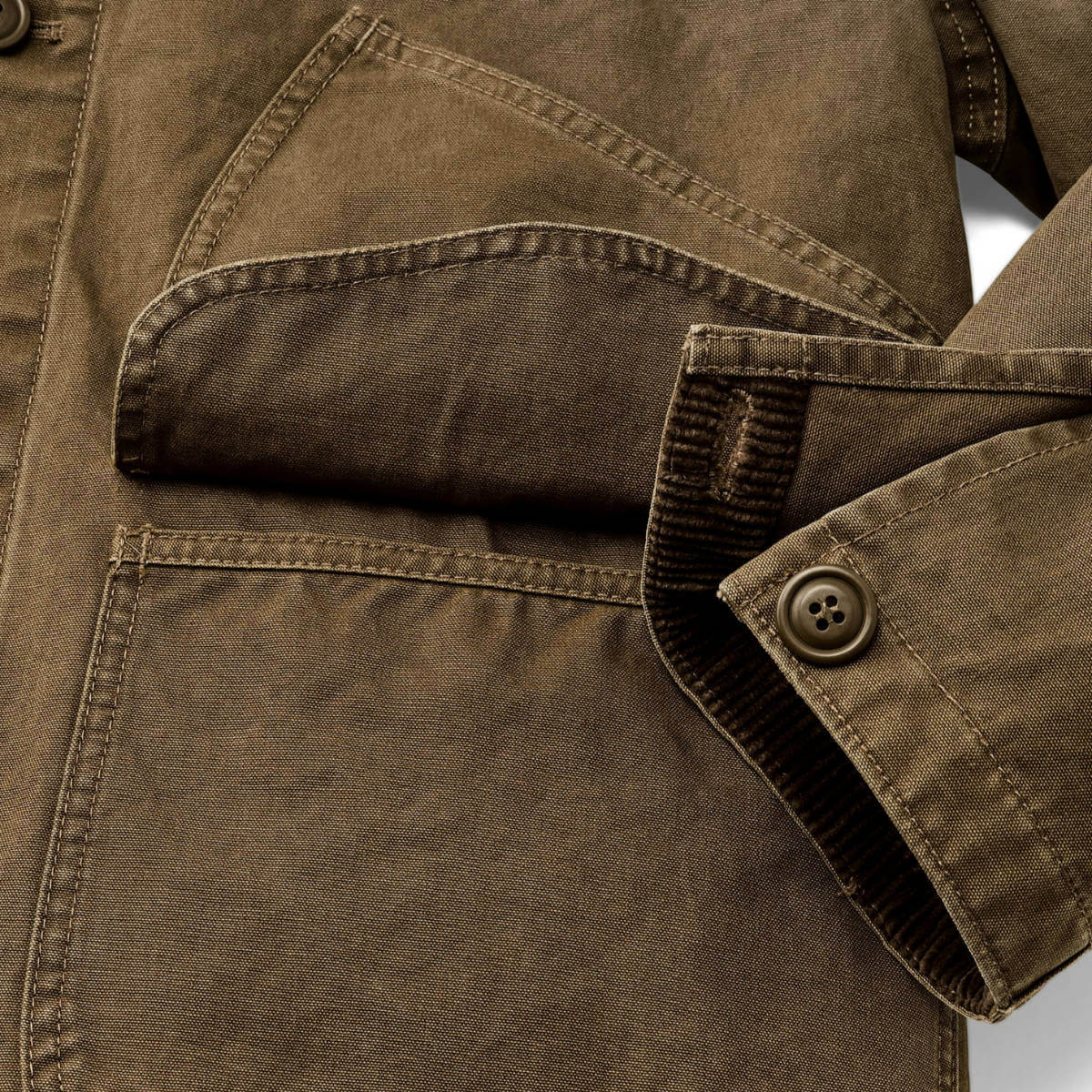 Close-up of a brown jacket with a buttoned pocket on a white background