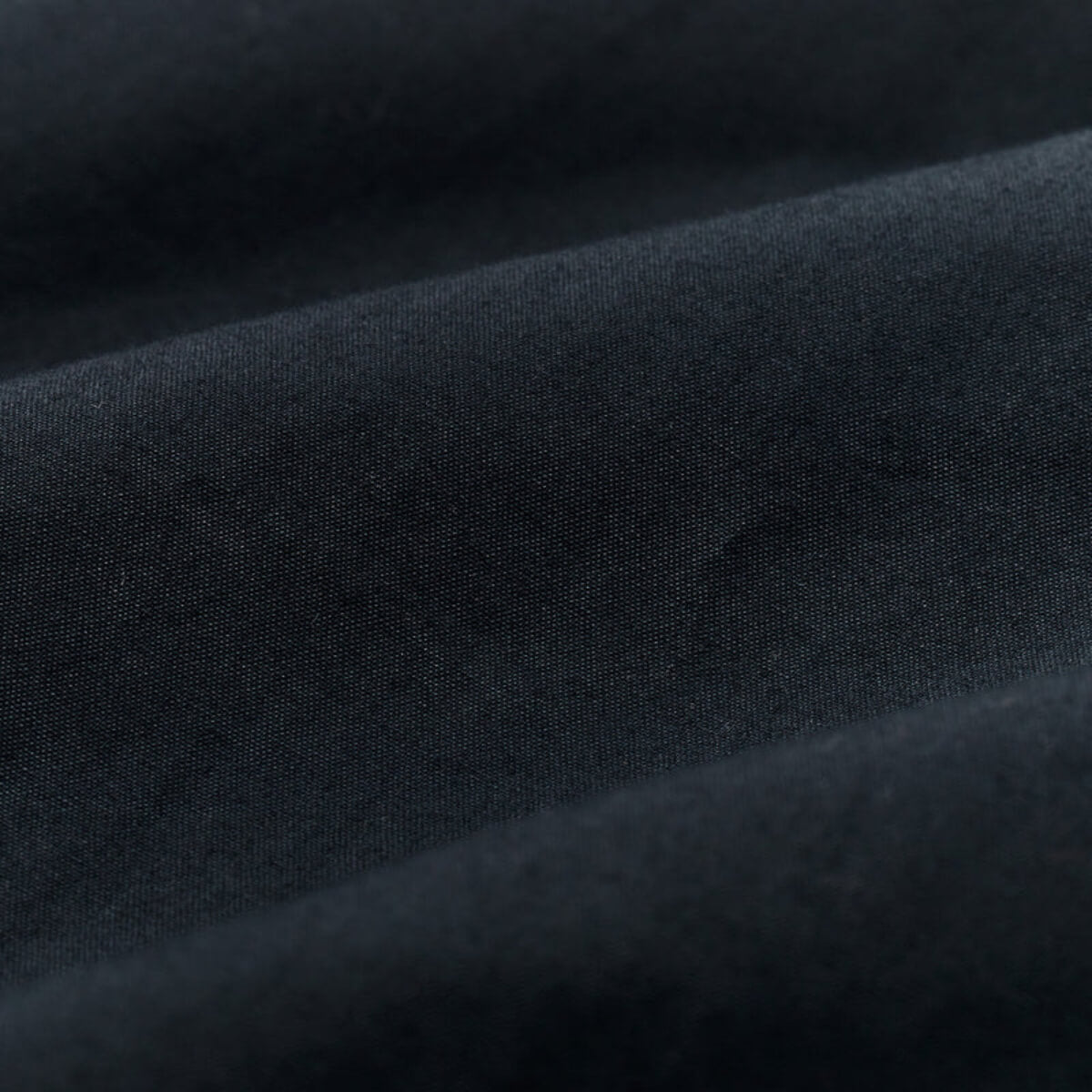 Close-up of dark gray fabric with a textured surface