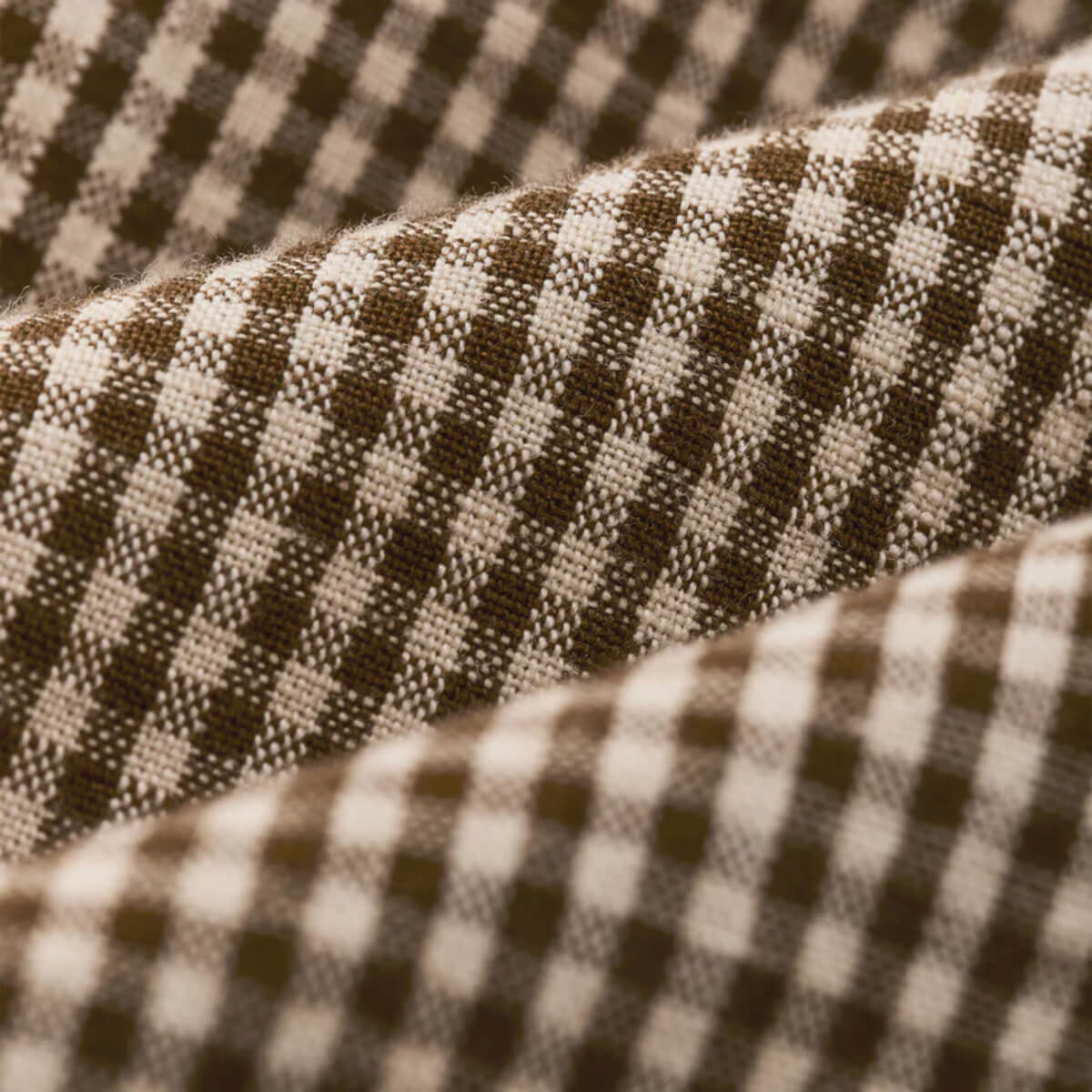 Close-up of checkered fabric with brown and beige pattern