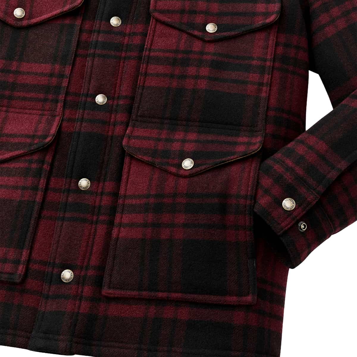 Close-up of a red and black plaid flannel shirt jacket with silver snap buttons and flap chest pockets, shown on a white background.