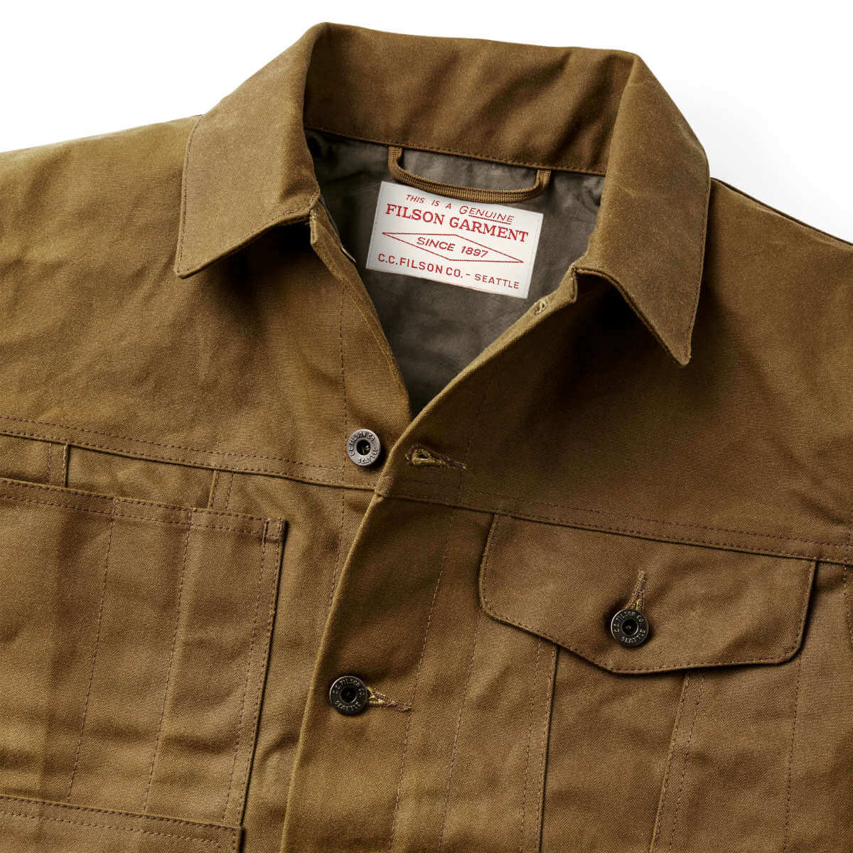 Brown jacket with Filson Garment label on a white background