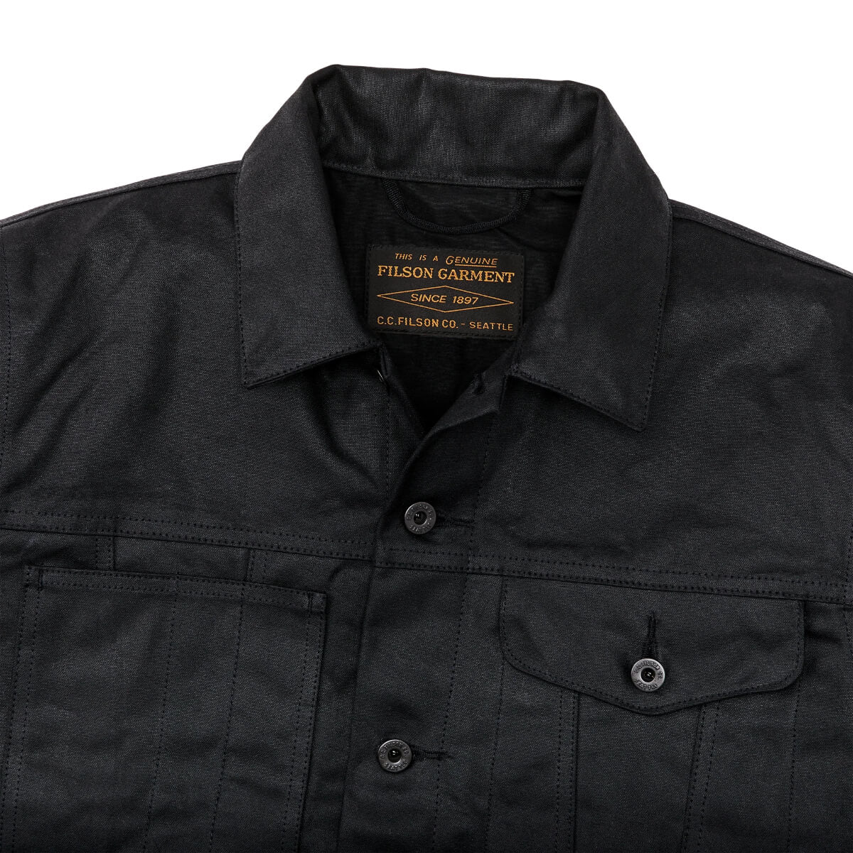 Black jacket with a visible Filson garment label on a white background