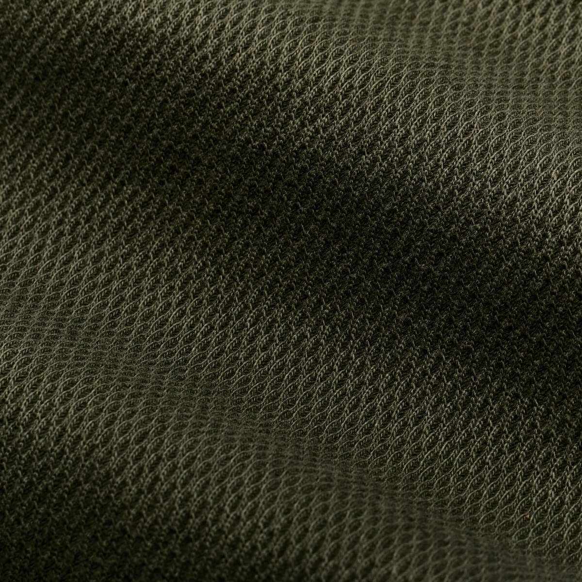 Close-up of dark green fabric texture