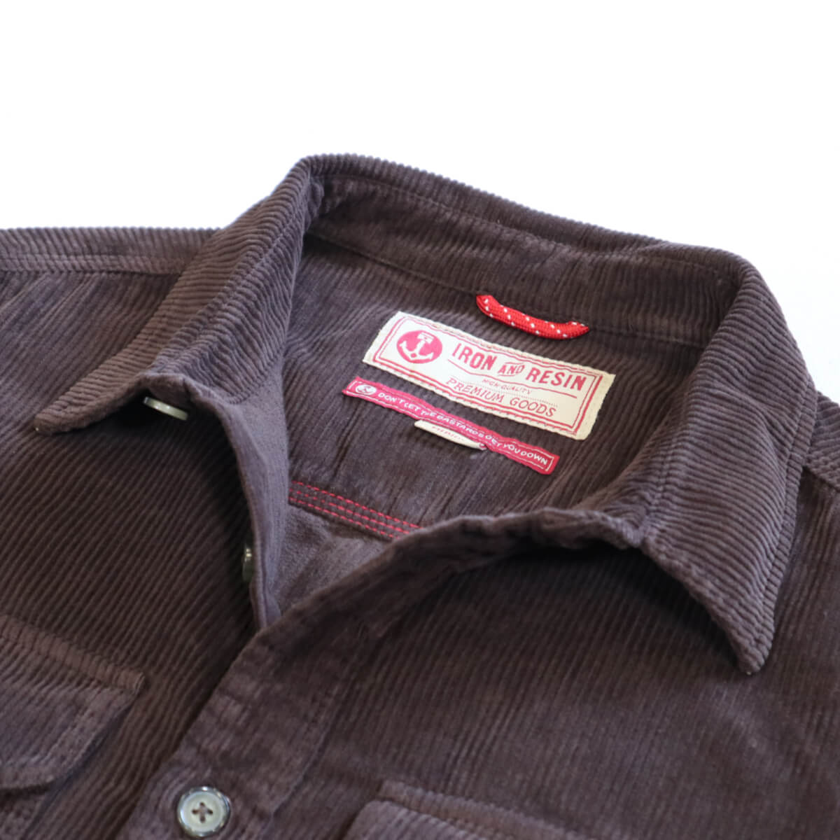 Brown corduroy shirt with a brand label on a white background
