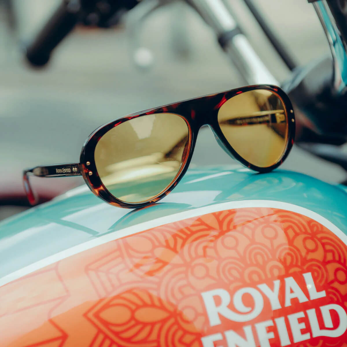 Sunglasses with gold lenses on a Royal Enfield motorcycle