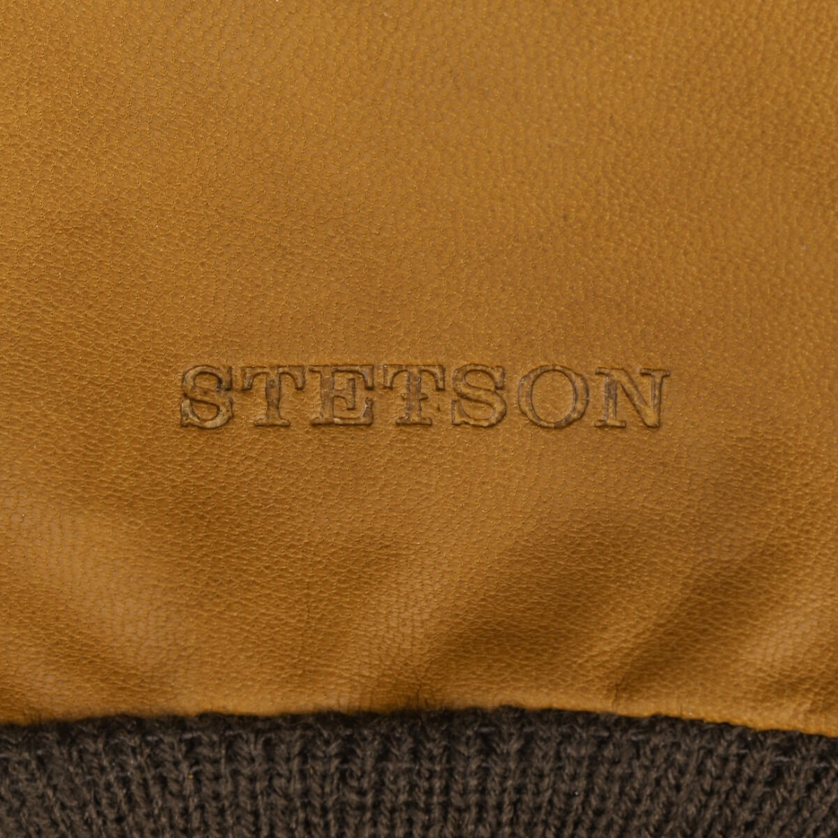 Close-up of Stetson logo on brown leather surface