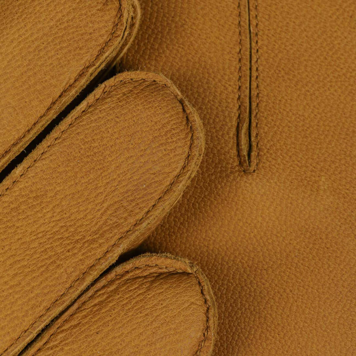 Close-up of brown leather texture with stitching details