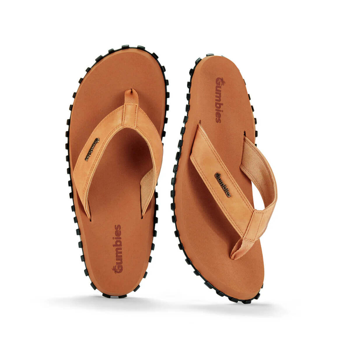 Pair of tan flip flops with black soles on a white background