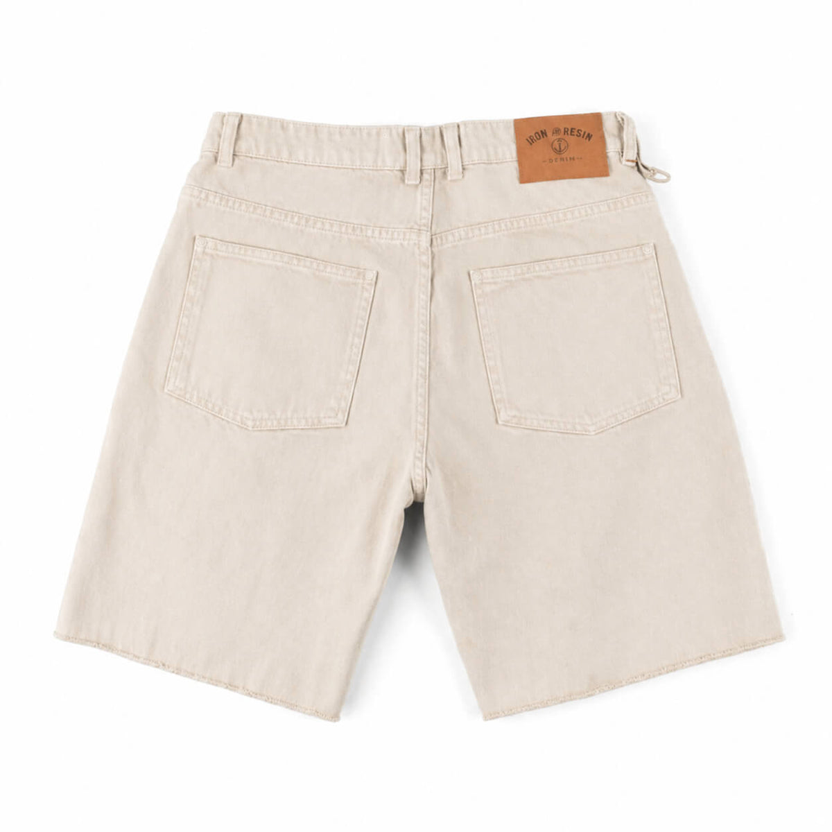 Beige shorts with a brand label on a white background