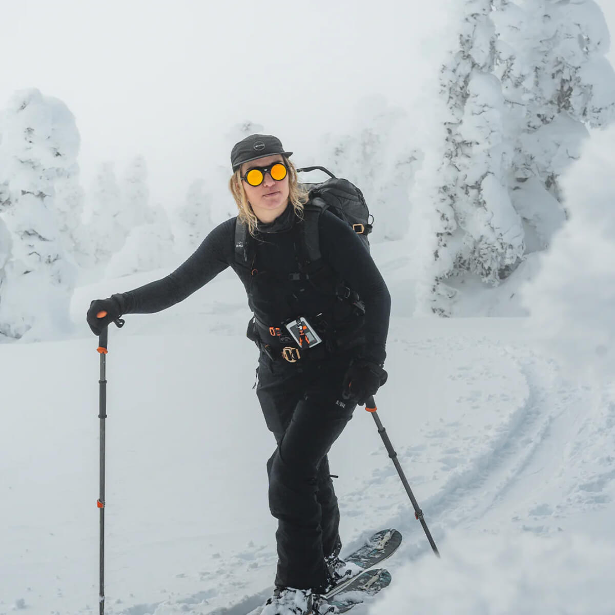Person skiing through a snowy landscape with trees