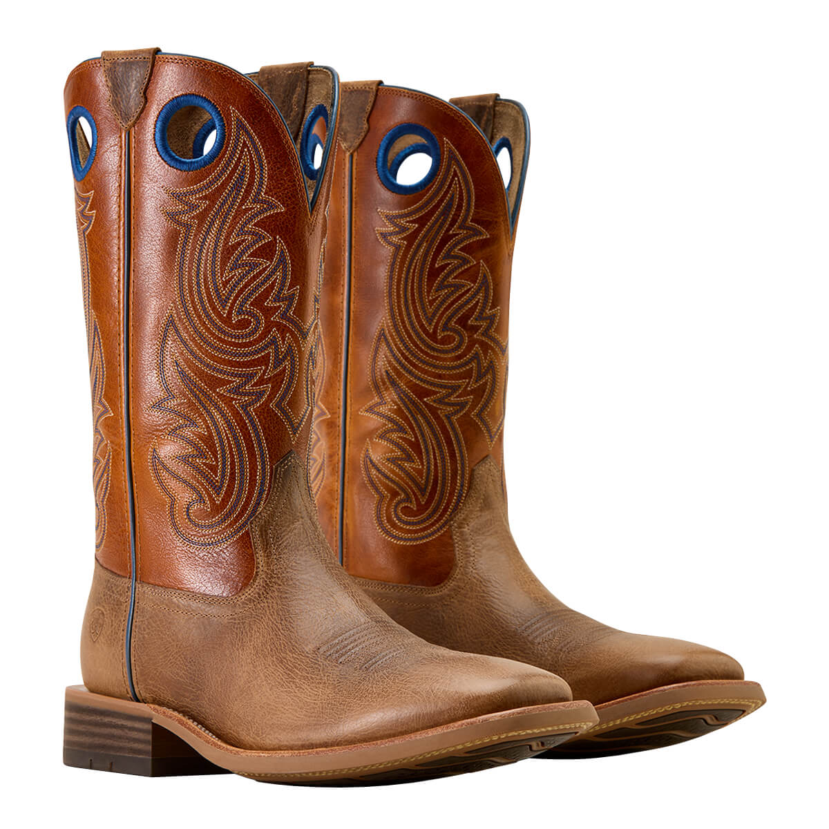 Pair of brown cowboy boots with intricate designs on a white background