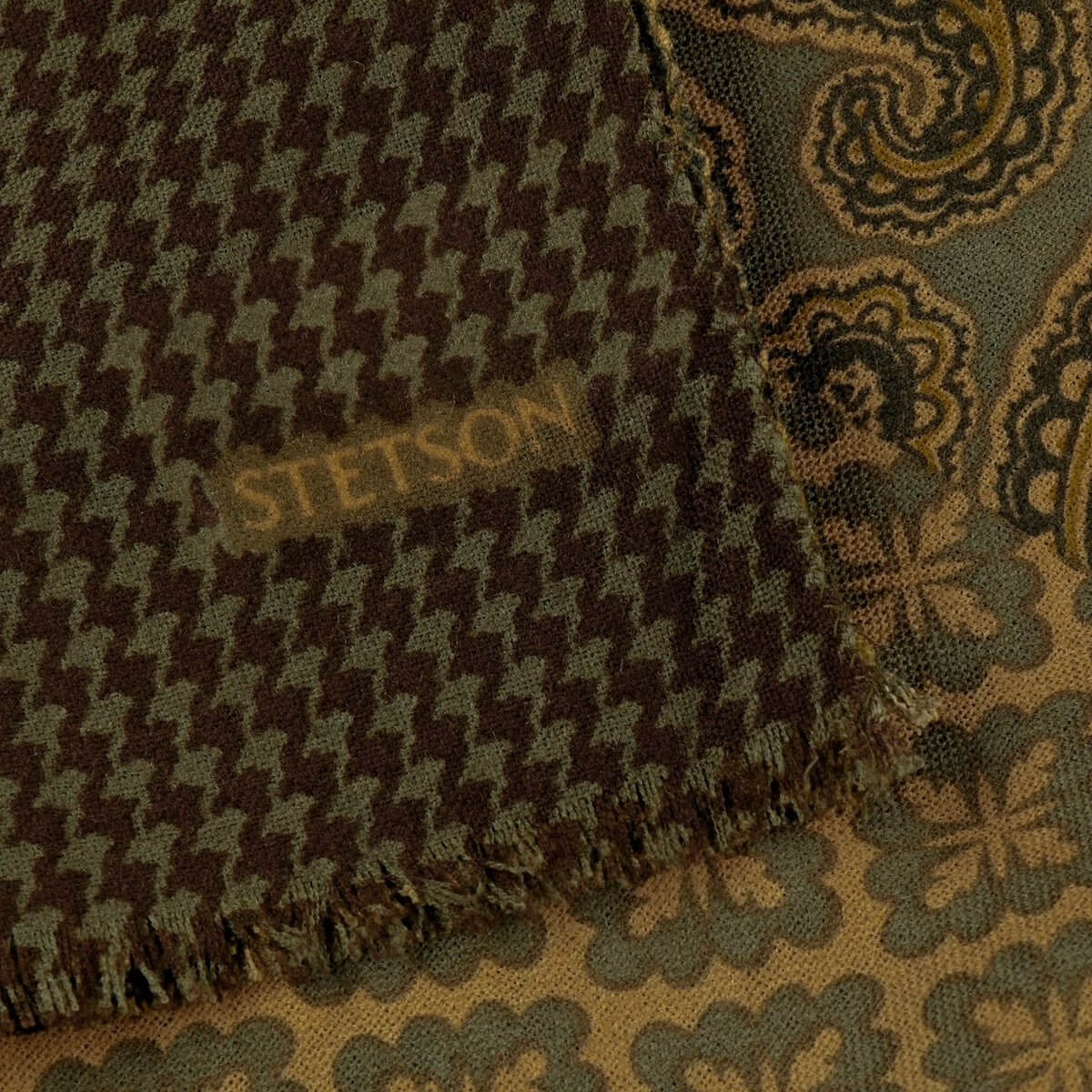 Textured fabric with a houndstooth pattern and paisley design, featuring the Stetson brand.