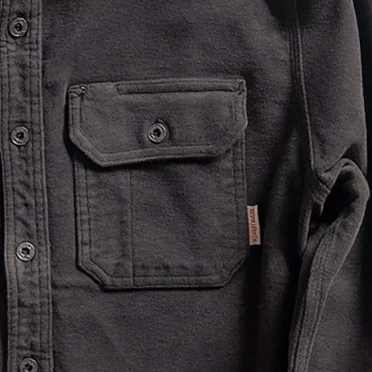 Close-up of an Iron and Resin Journeyman Moleskin Shirt with a chest pocket and a small brown woven brand tag