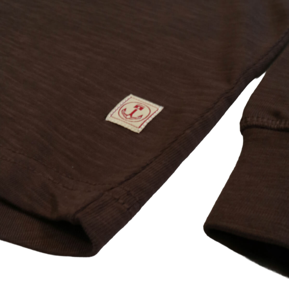 Close-up of a brown fabric with a logo on a white background
