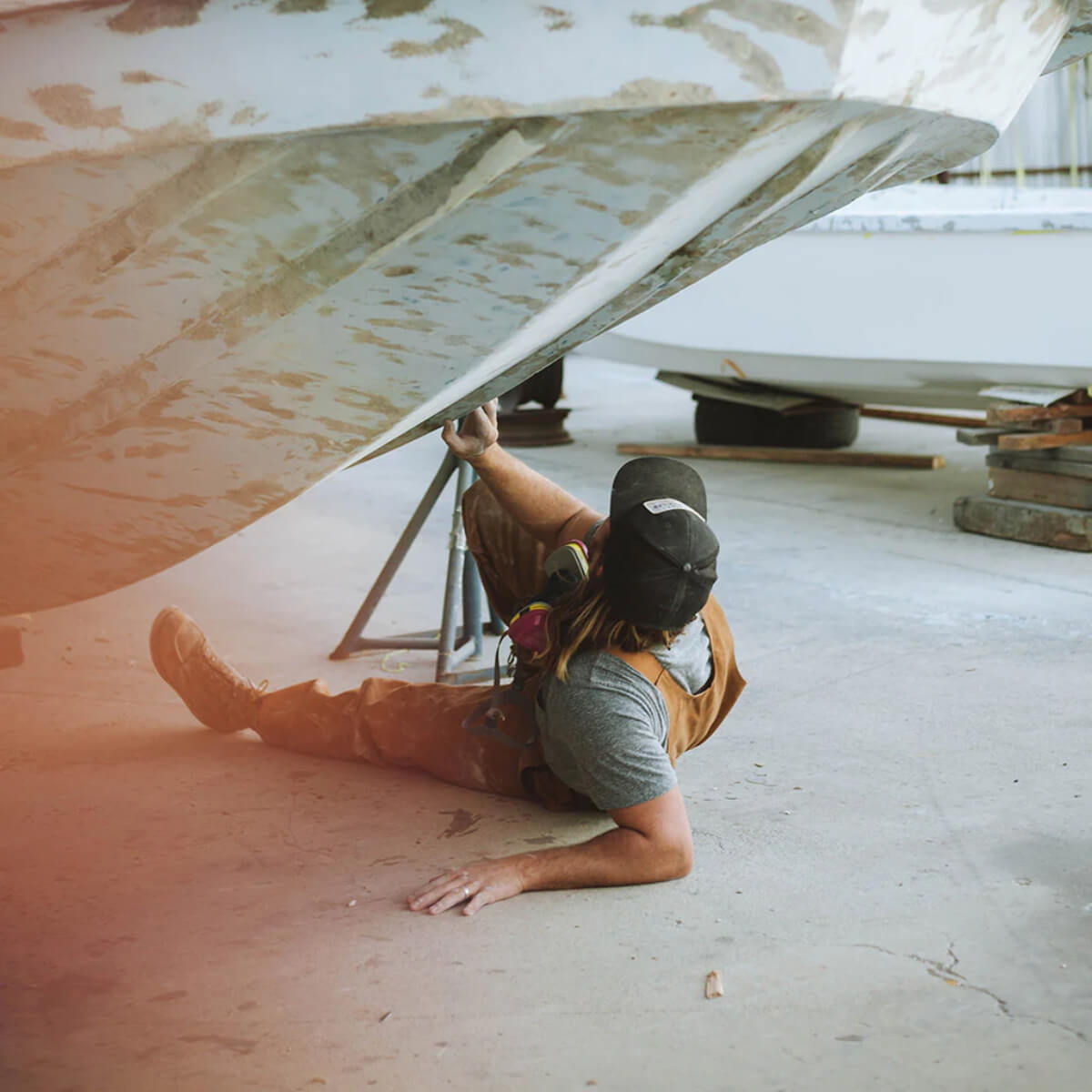 Person working on a boat in a garage