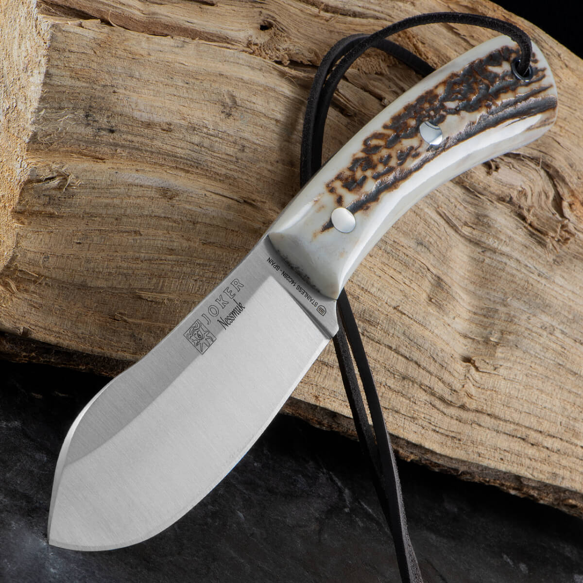 Knife with a staghorn handle on a wooden background