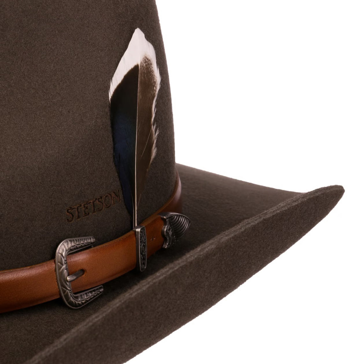 A close-up of a dark brown Stetson Limington Western Wool hat with a brown leather strap, silver buckle, and a dark feather attached near the crown, on a white background.