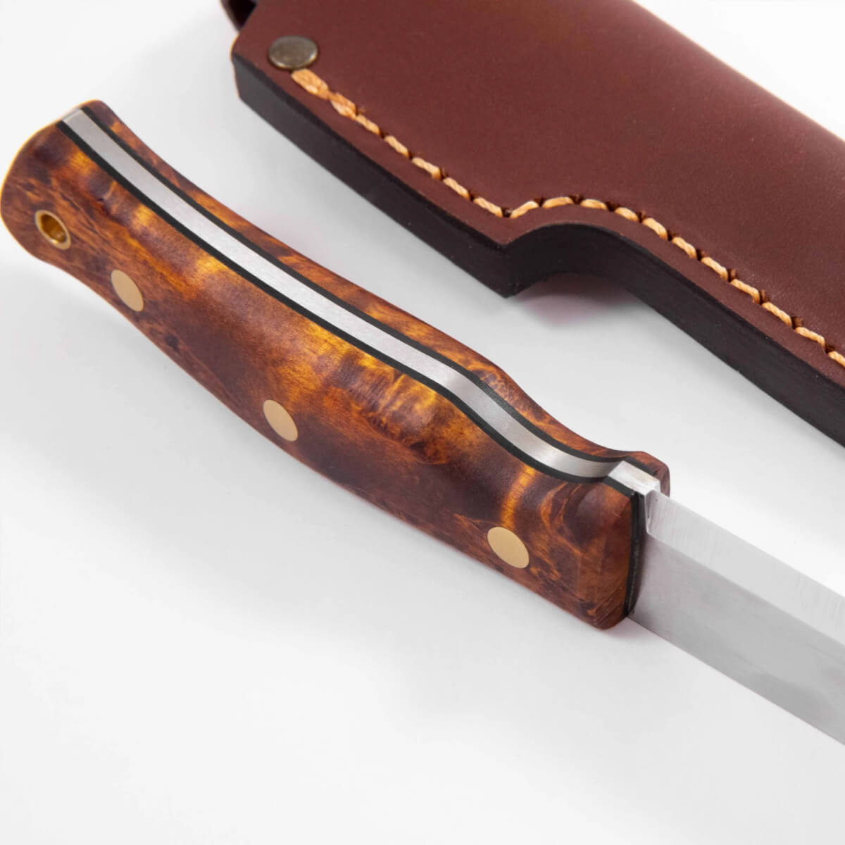 Folding knife with wooden handle and leather sheath on a white background