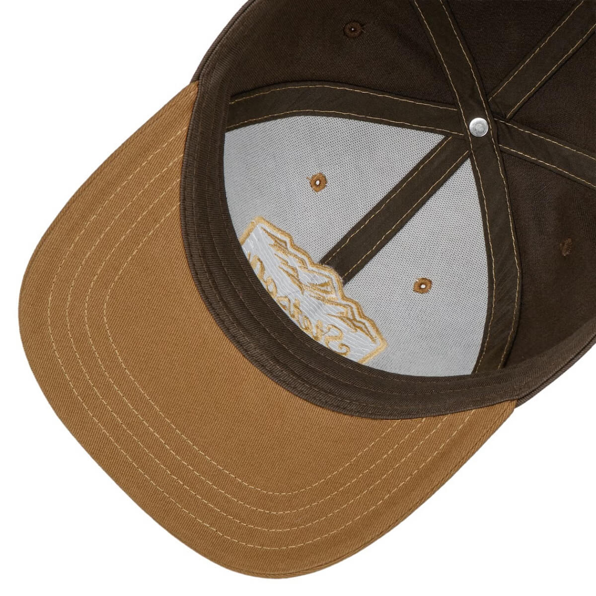 Brown and black cap with a visible brand logo on the inside visor.