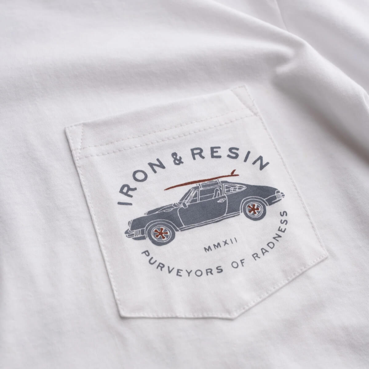 Logo on a white shirt with text 'IRON & RESIN' and a car illustration.