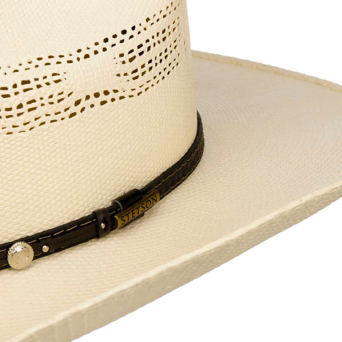 Close-up of a Stetson straw cowboy hat with a black band featuring a brand logo on a white background