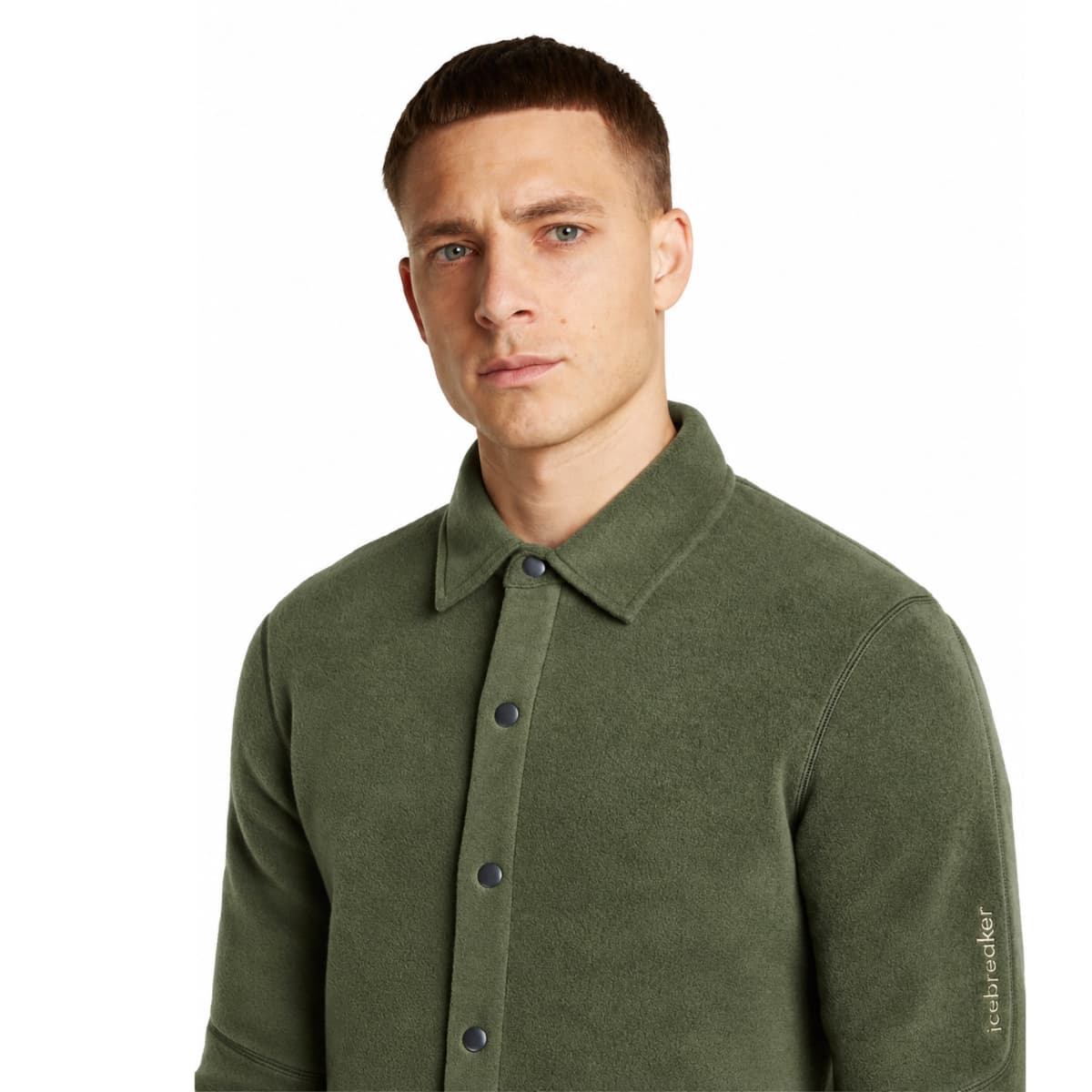 A man wearing an olive green Icebreaker merino wool shacket, photographed against a plain white background.
