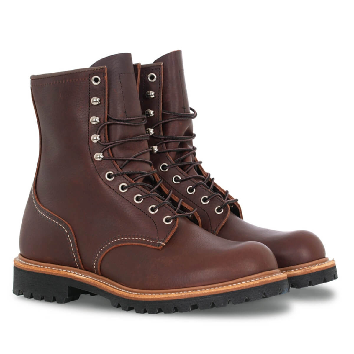 Pair of brown leather boots with laces on a white background