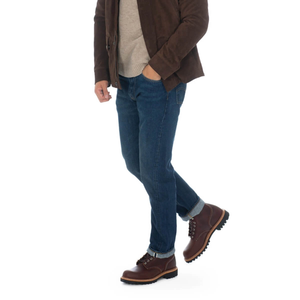 Person wearing a brown jacket, blue jeans, and brown boots on a white background