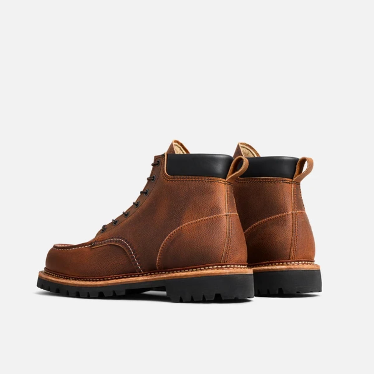A pair of Red Wing Norway Moc Toe Boot 8213 - Copper Rough and Tough boots with black soles and collar lining, shown from a three-quarters angle on a light gray background.