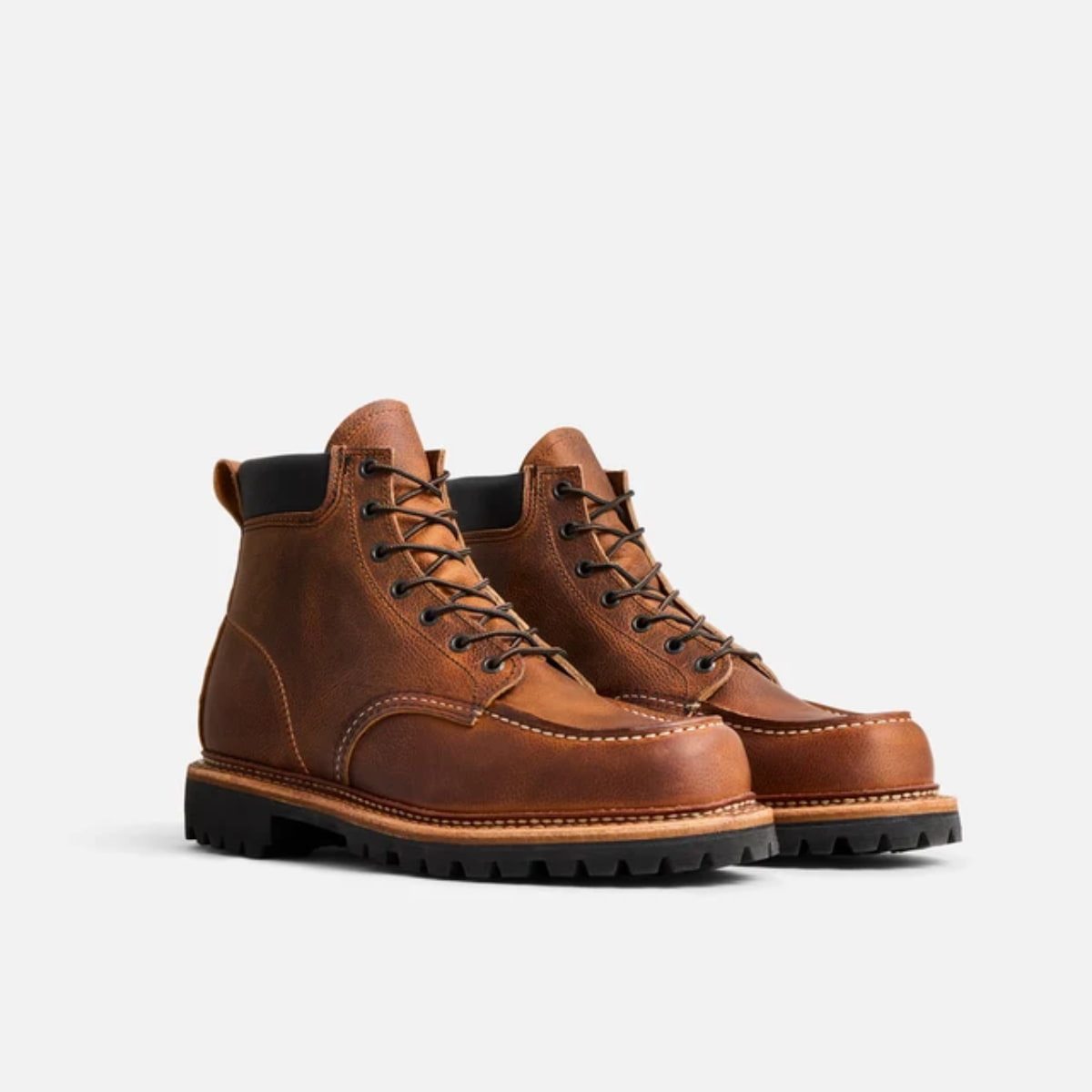 A pair of classic Red Wing Norway Moc Toe Boot 8213 - Copper Rough and Tough boots with black soles, shown from a three-quarters angle on a light gray background.